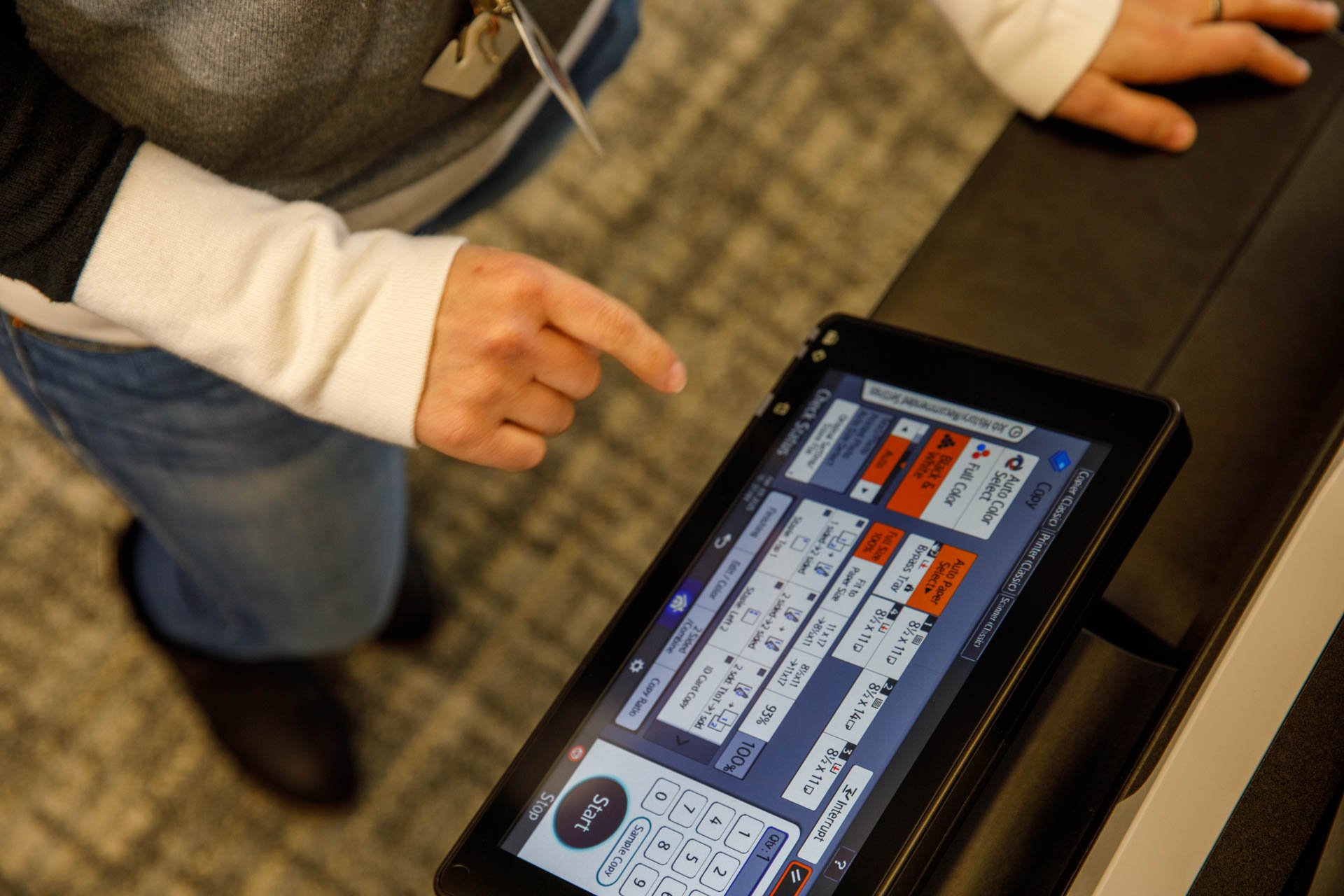an image of a loan officer securely scanning and sending loan documents using a multifunction device from eo johnson