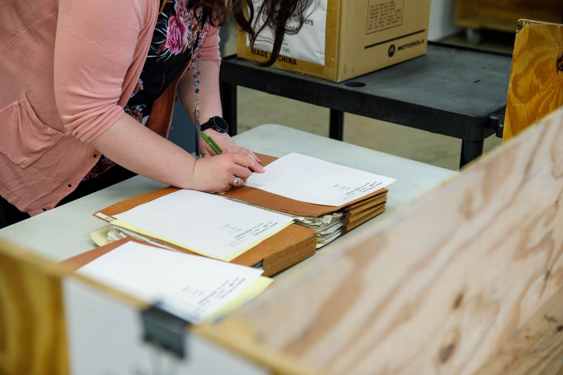 an image of a scanning professional keeping track of the chain of custody for physical files at the eo johnson scanning office