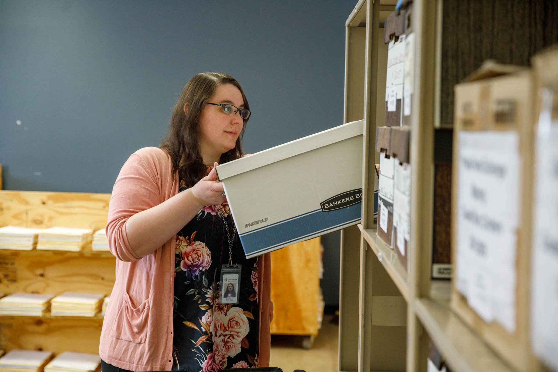 image of paper files being handled securely at eo johnson's document scanning facility