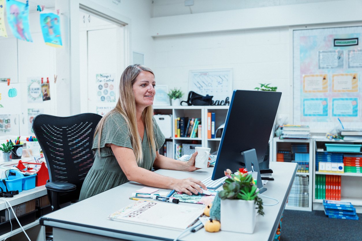 image of a teacher working at her computer