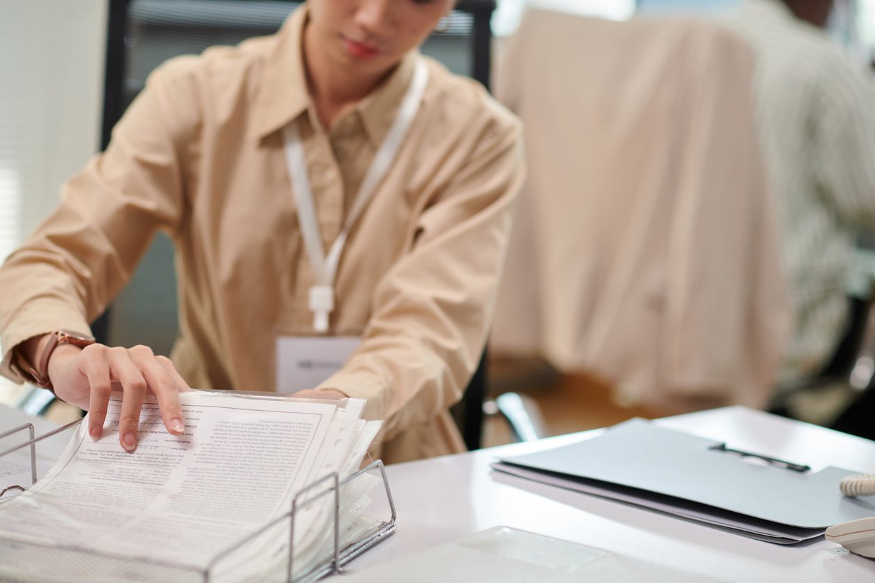 image of administrative professional sifting through paper files