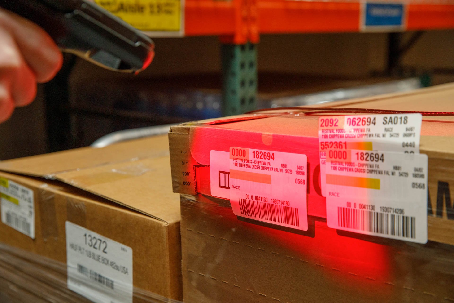 an image of a warehouse employee scanning in boxes of inventory using a zebra wireless barcode scanner