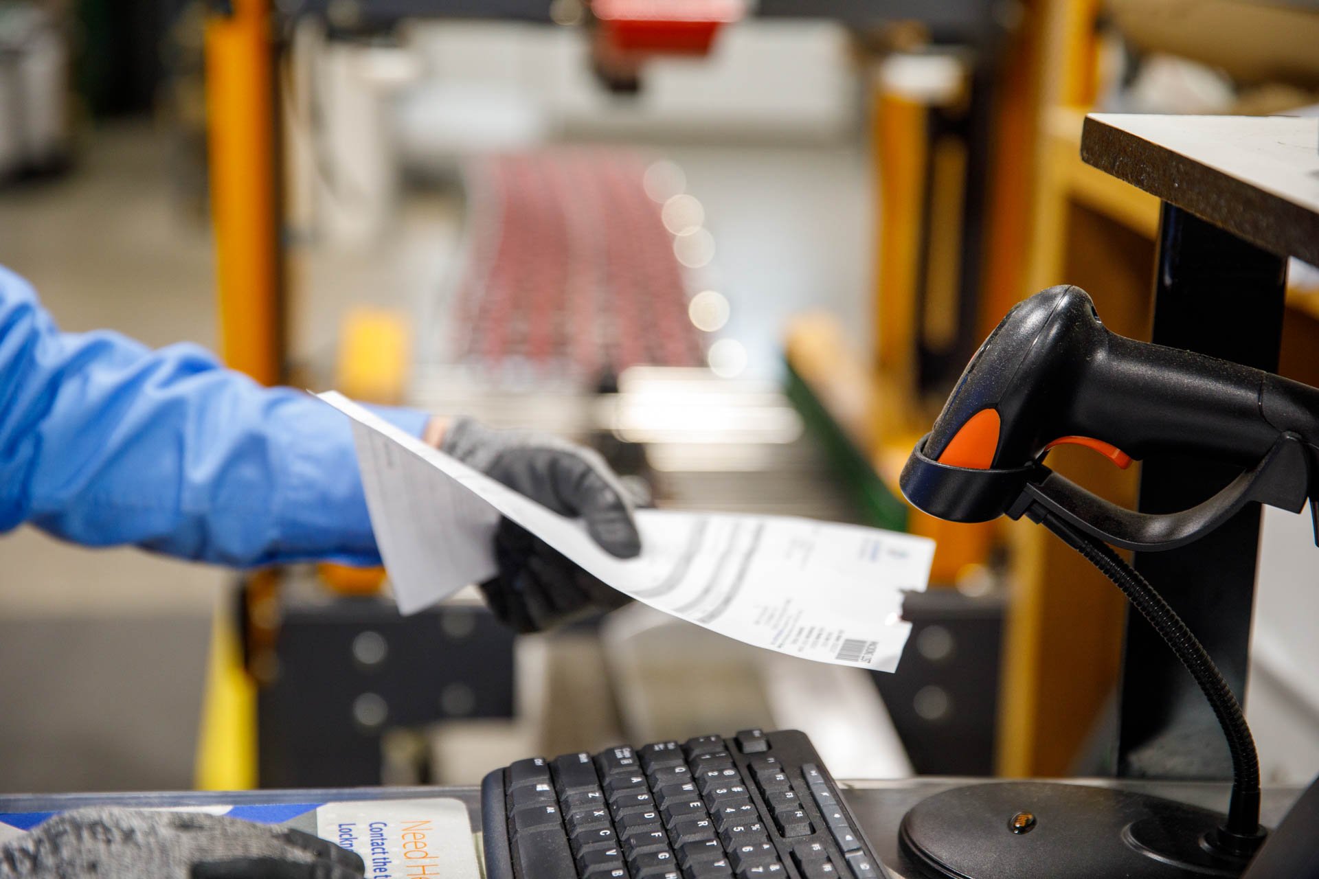 an image of a warehouse employee scanning a packing slip barcode with a zebra barcode scanner