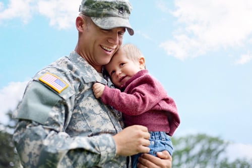 image of a veteran holding his child