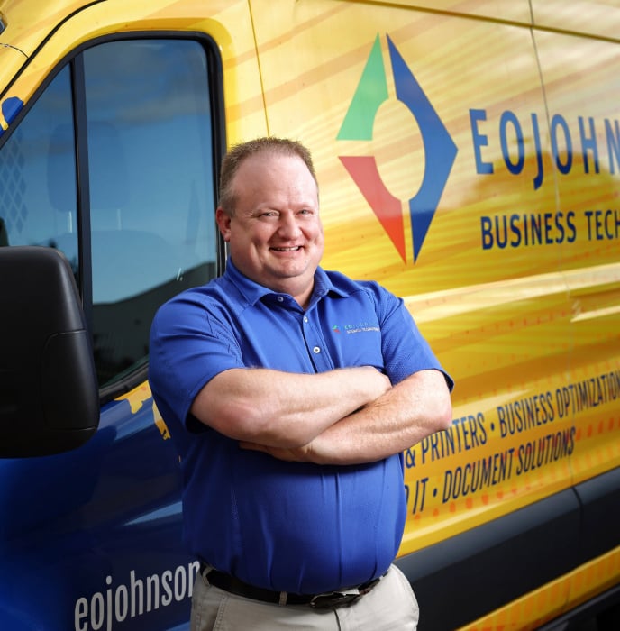 image of a local printer service technician standing in front of his van