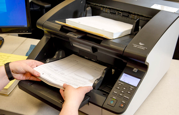 an image of documents being scanned in EO Johnson's secure scanning facility.